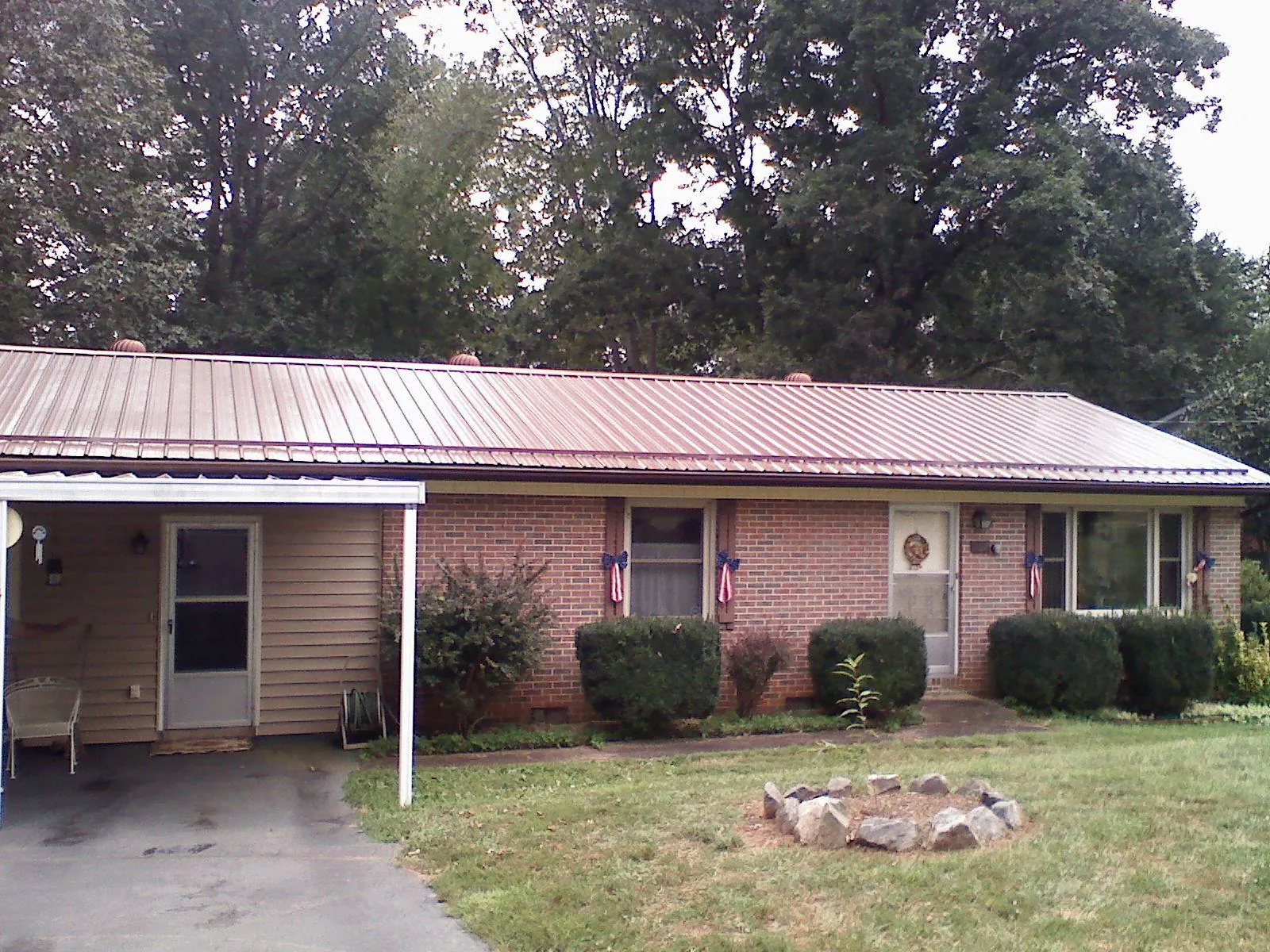 Bronze metal roof and carport on a brick ranch home — Roof Repair work by our crew in Rocklin