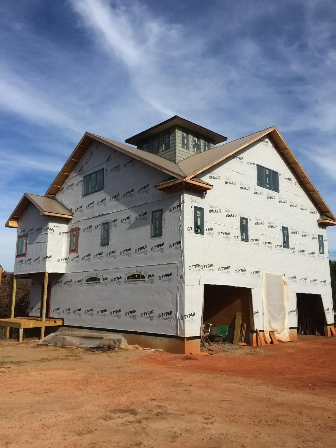 New two story house under construction with a cupola and gabled roofs in Rocklin